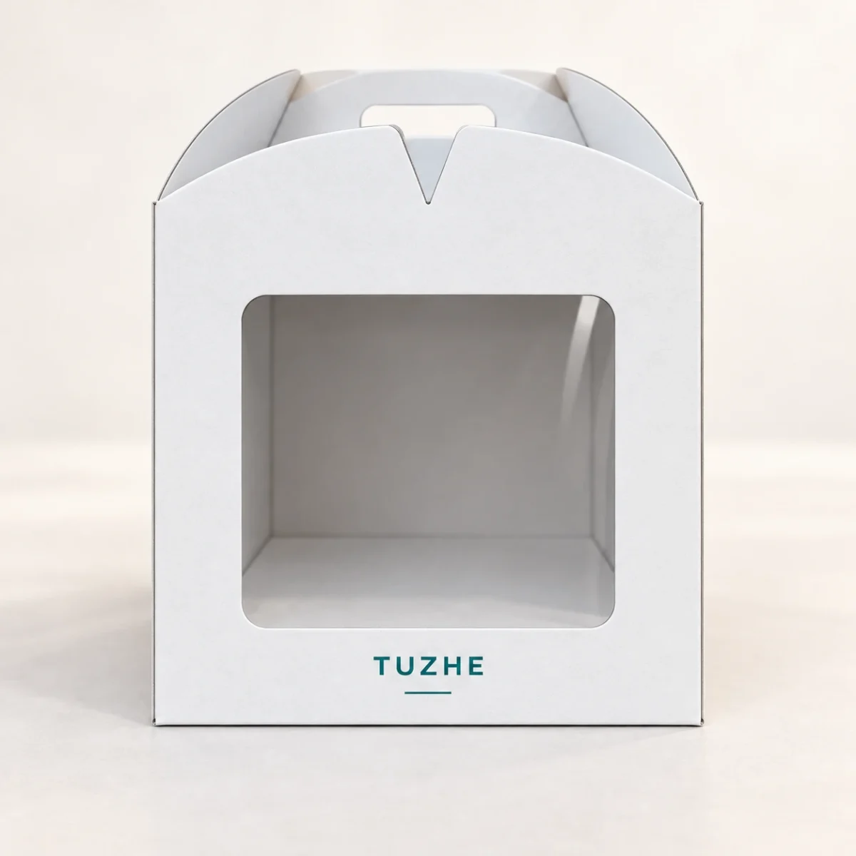AI design concept: frontal view of a white TUZHE cake carrier with clear front window, curved carry top and teal wordmark