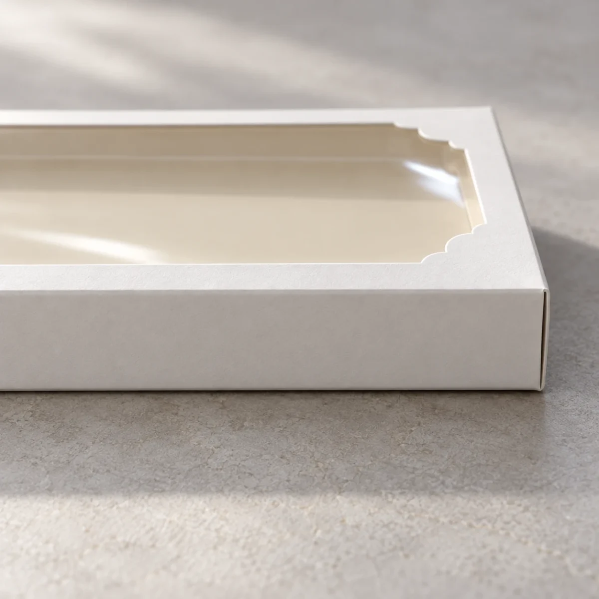 AI design concept: low-angle detail of the shallow white carton edge and curved-corner clear window