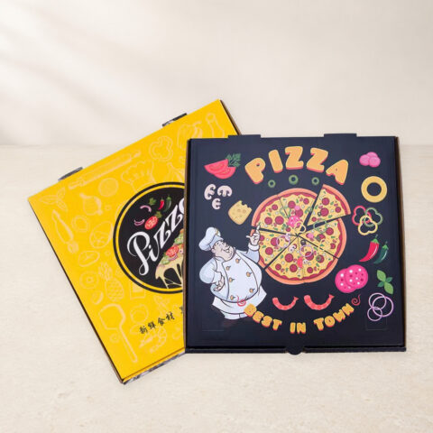 Overlapping yellow and black printed pizza boxes with visible closure tabs