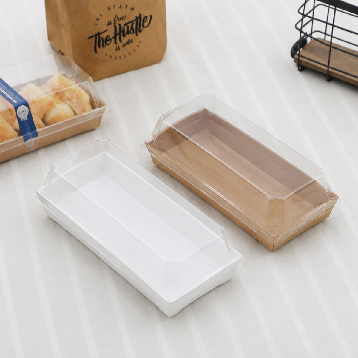 Rectangular Dessert Boxes with Paper Trays and Clear Lids White and kraft rectangular paper dessert trays with clear fitted lids on a light tablecloth