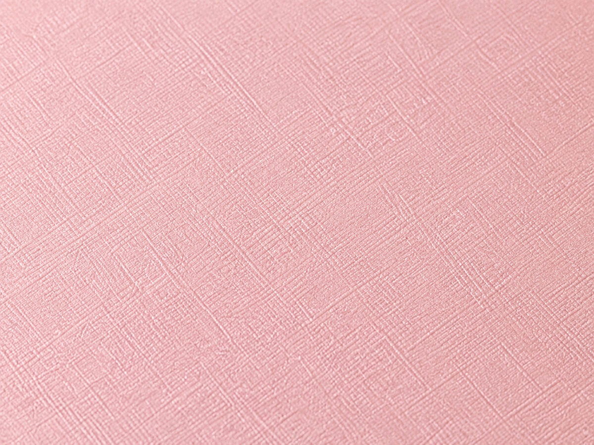 Close-up of peach paper with a fine crosshatch surface texture