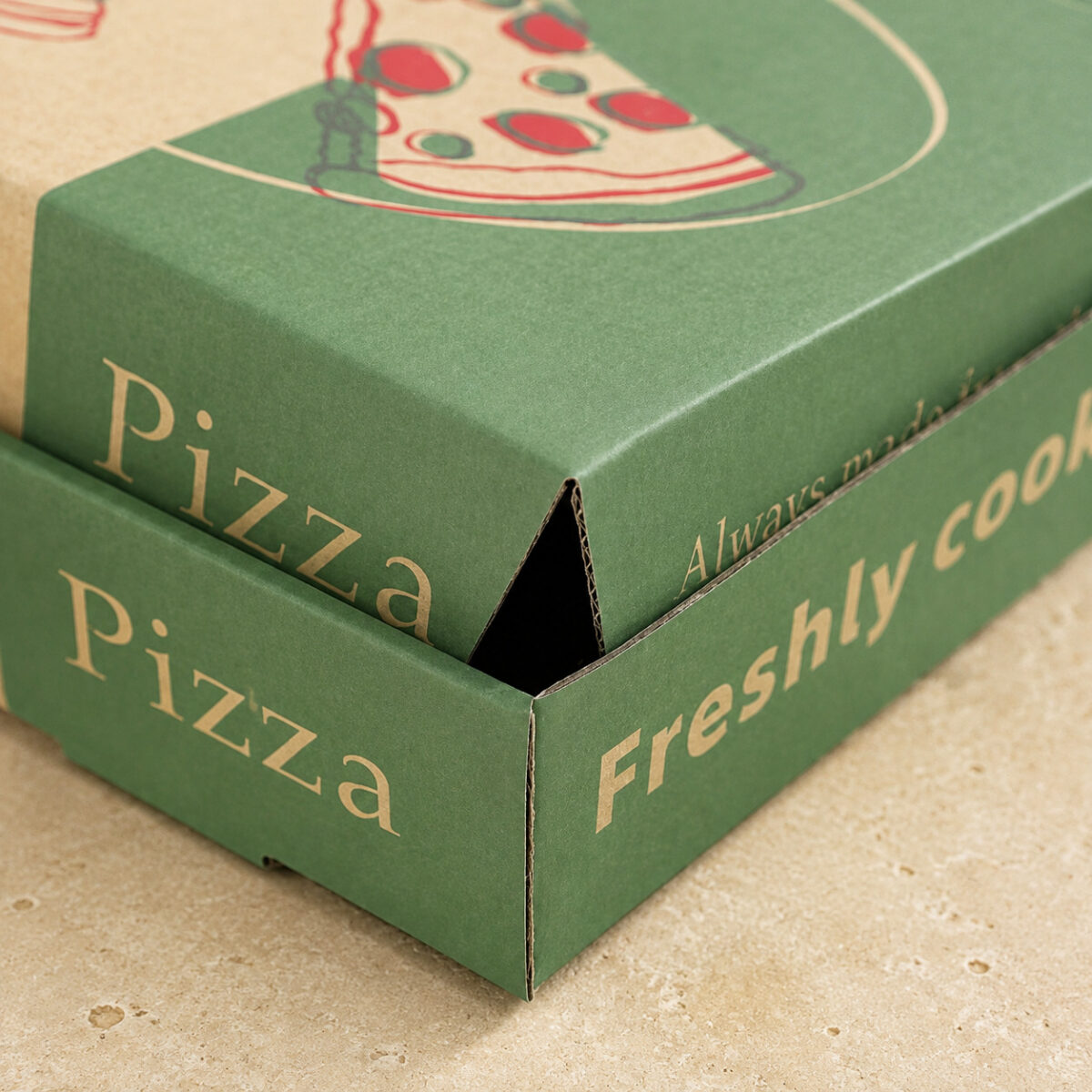 Close-up of overlapping printed pizza box panels and the triangular corner gap