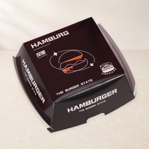 Printed burger carton with folding side flaps and a front thumb notch