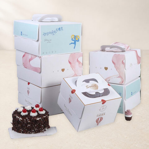 Six printed cake boxes with carry handles in mint, pink and white designs