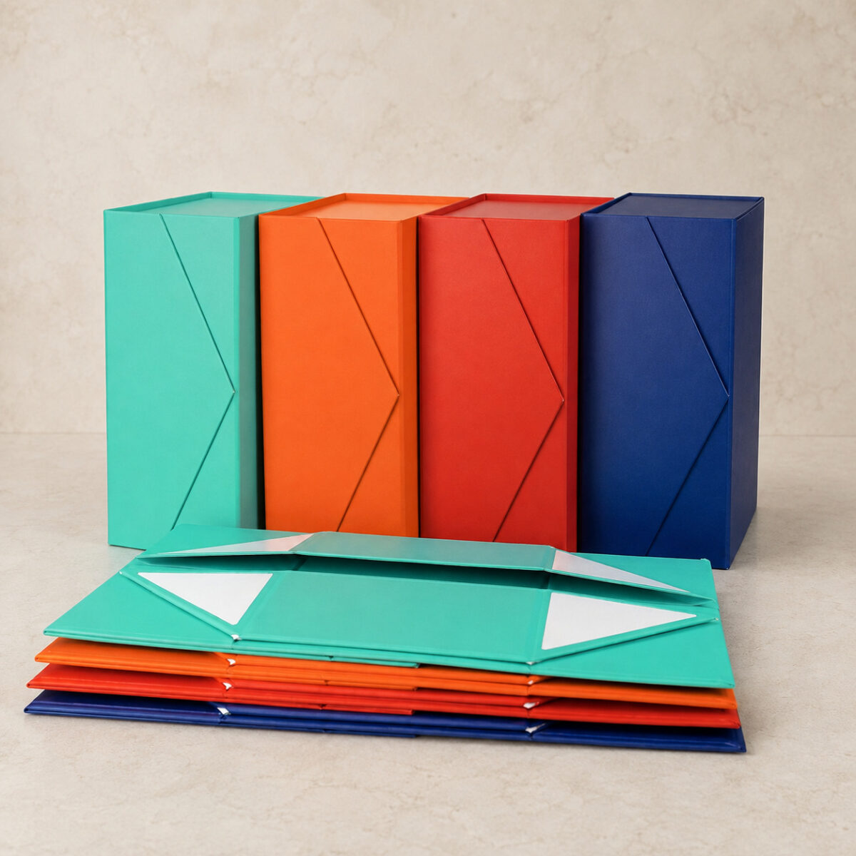 Four colored folding gift boxes displayed upright beside matching flat-packed boxes