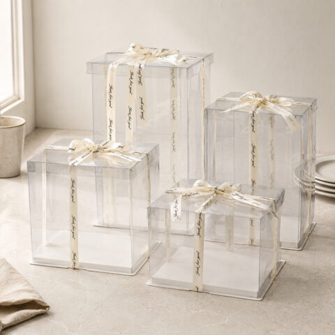 Four square clear cake boxes with transparent folded lids, white square bases and ivory Just for you ribbons