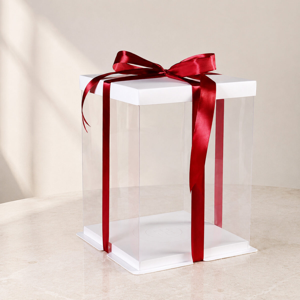 Tall Square Clear Cake and Gift Boxes Tall empty clear square gift cake box with a white lid, white base and red satin ribbon bow